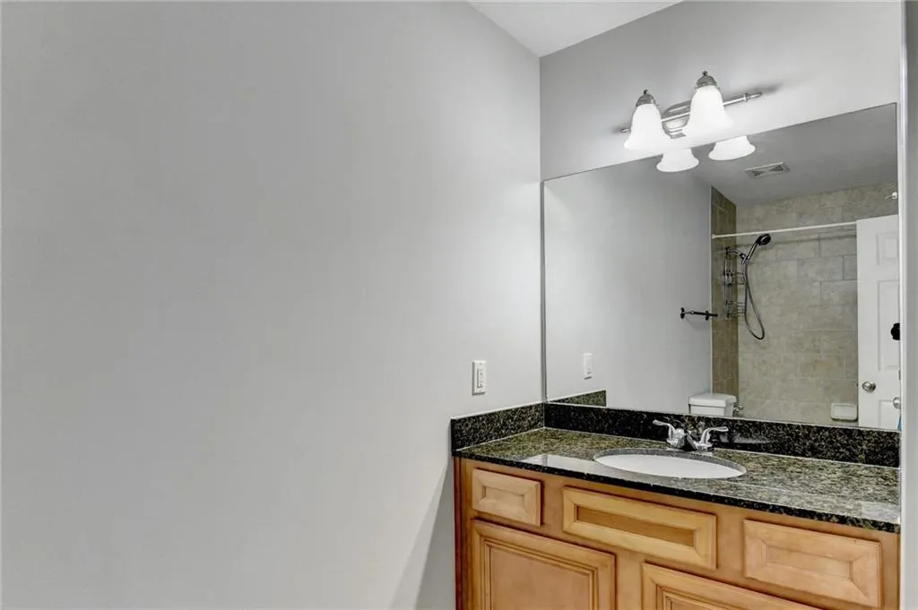 Bathroom with vanity and a shower with shower curtain
