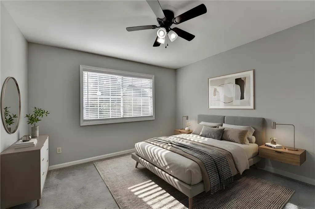 Bedroom featuring a ceiling fan and light colored carpet