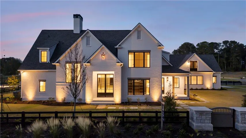 Modern farmhouse architecture featuring white brick and vertical siding