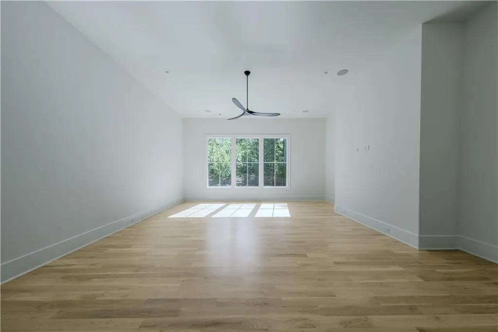 Empty room with light hardwood / wood-style flooring
