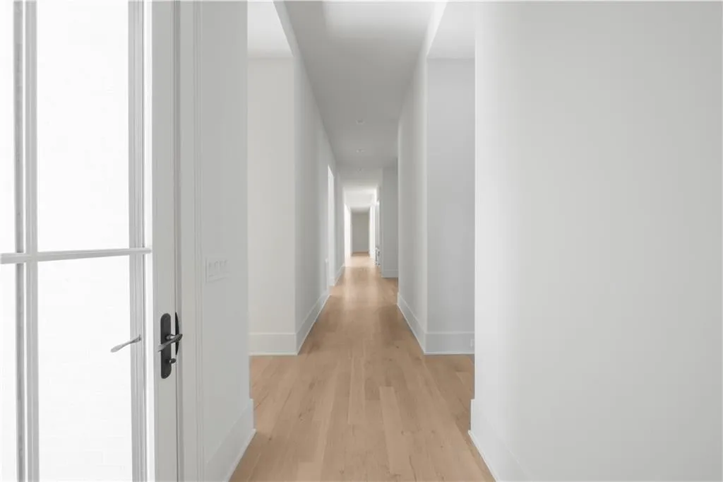 Hallway with light hardwood / wood-style floors