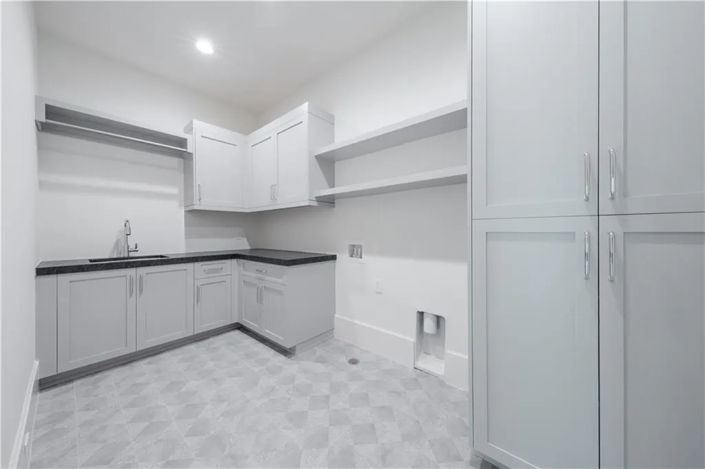 Washroom featuring cabinets, sink, and hookup for a washing machine