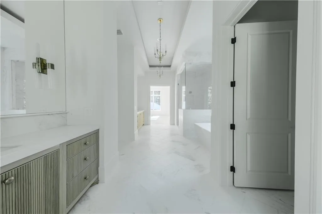 Hallway featuring a notable chandelier