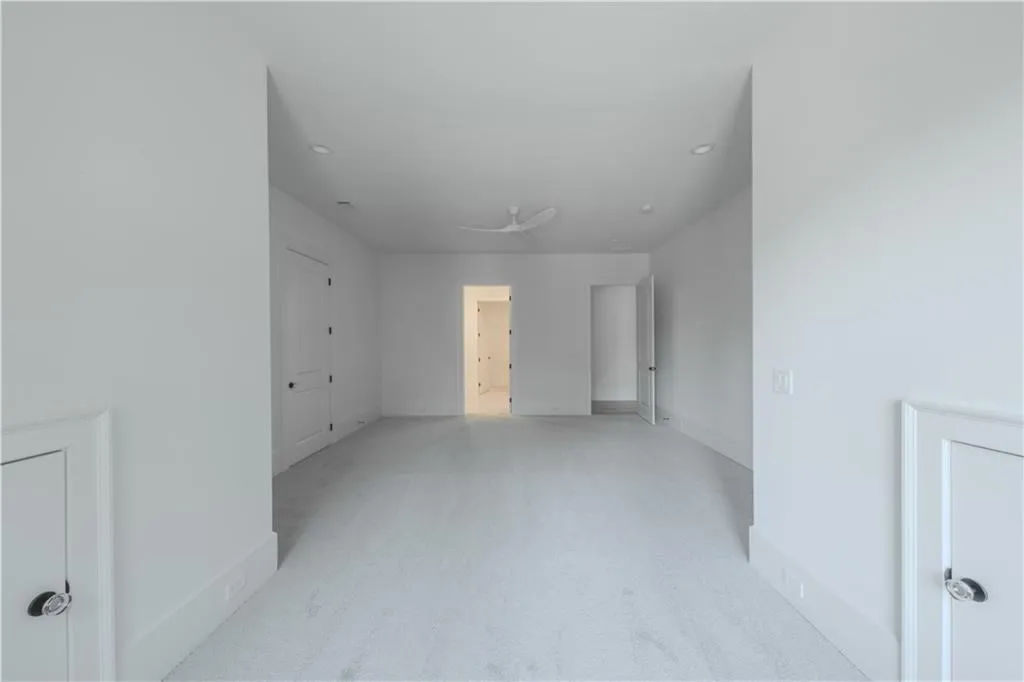 Carpeted spare room with ceiling fan