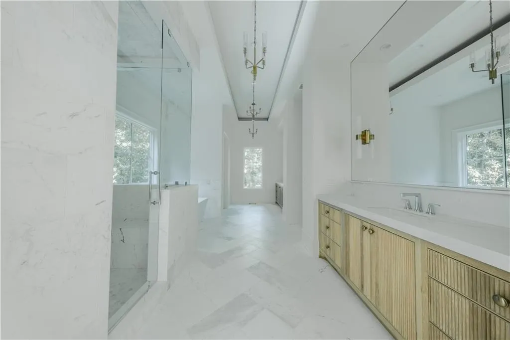 Bathroom featuring separate shower and tub and vanity