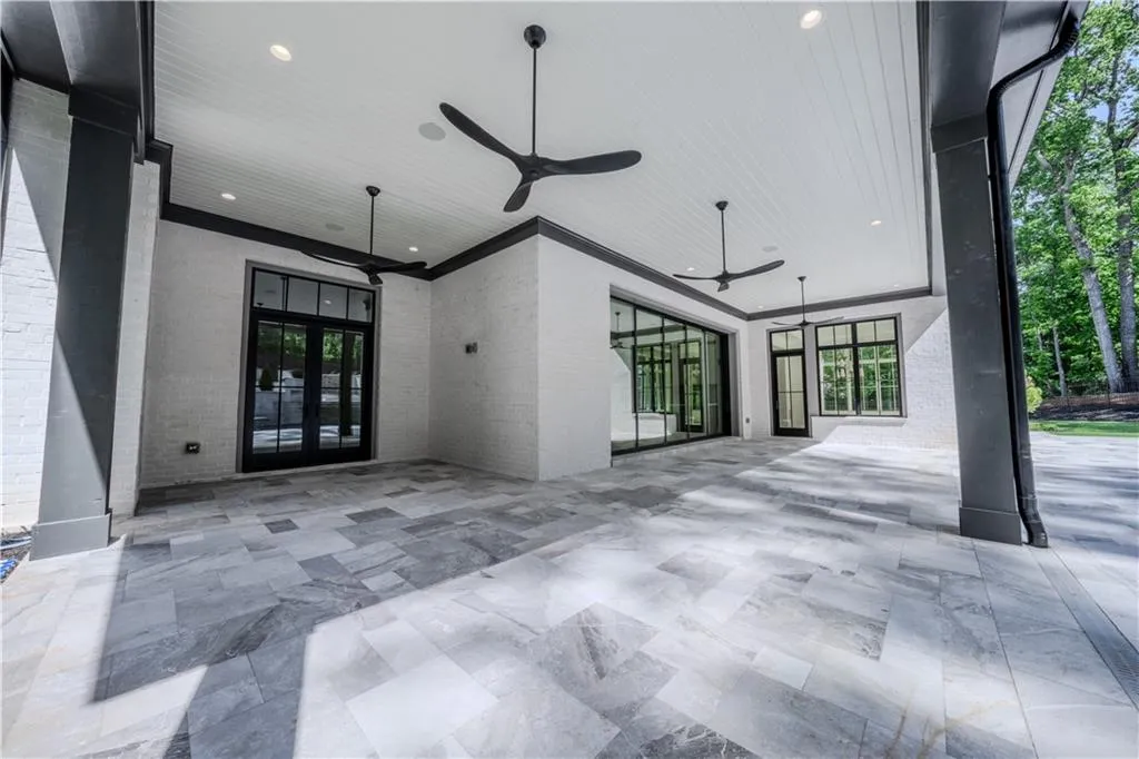 View of patio featuring french doors and ceiling fan