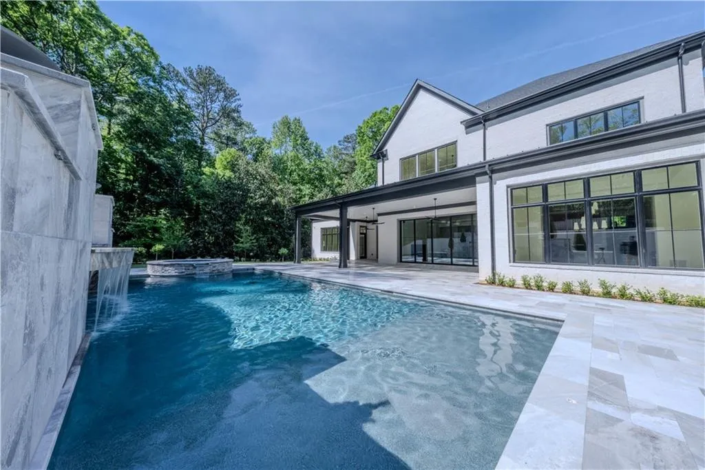View of pool with pool water feature, an in ground hot tub, and a patio