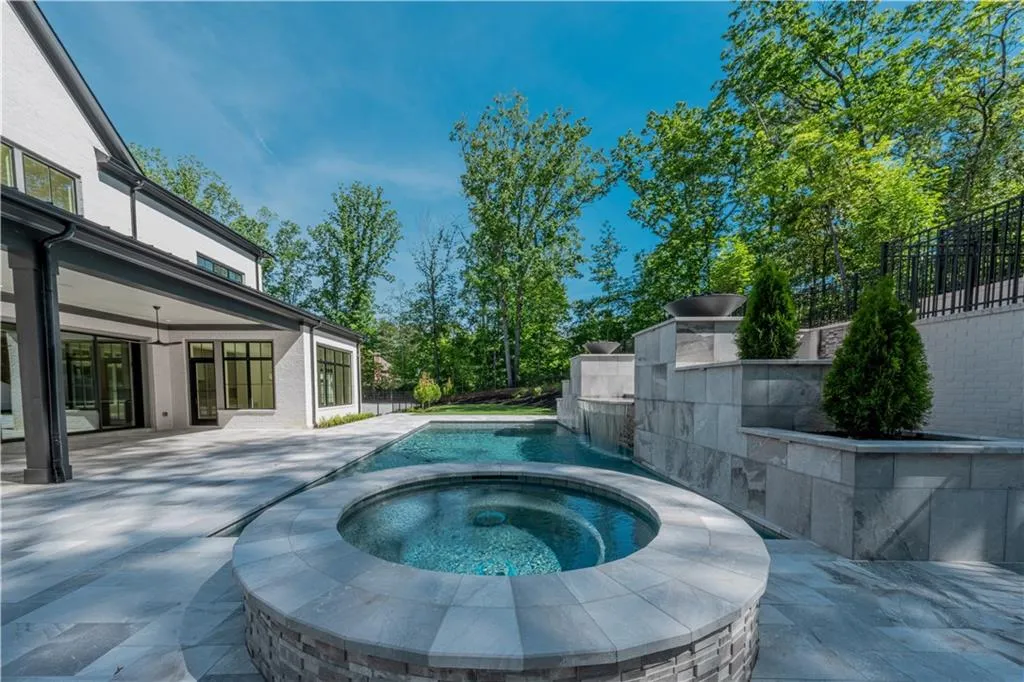 View of pool featuring an in ground hot tub and a patio