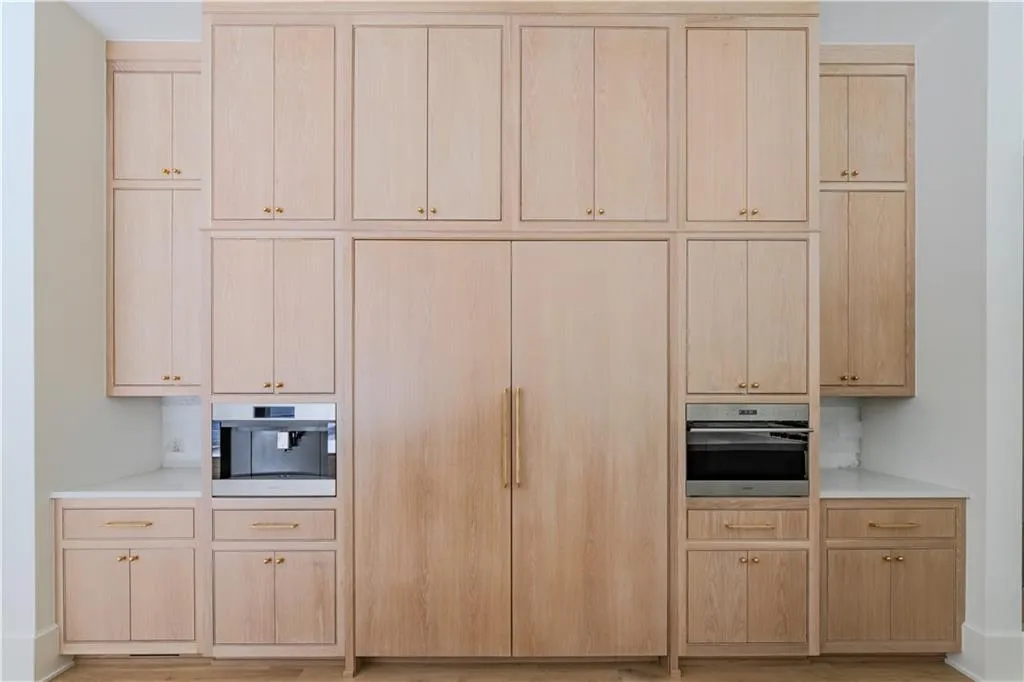 Kitchen featuring wall oven, light brown cabinets, and stainless steel oven