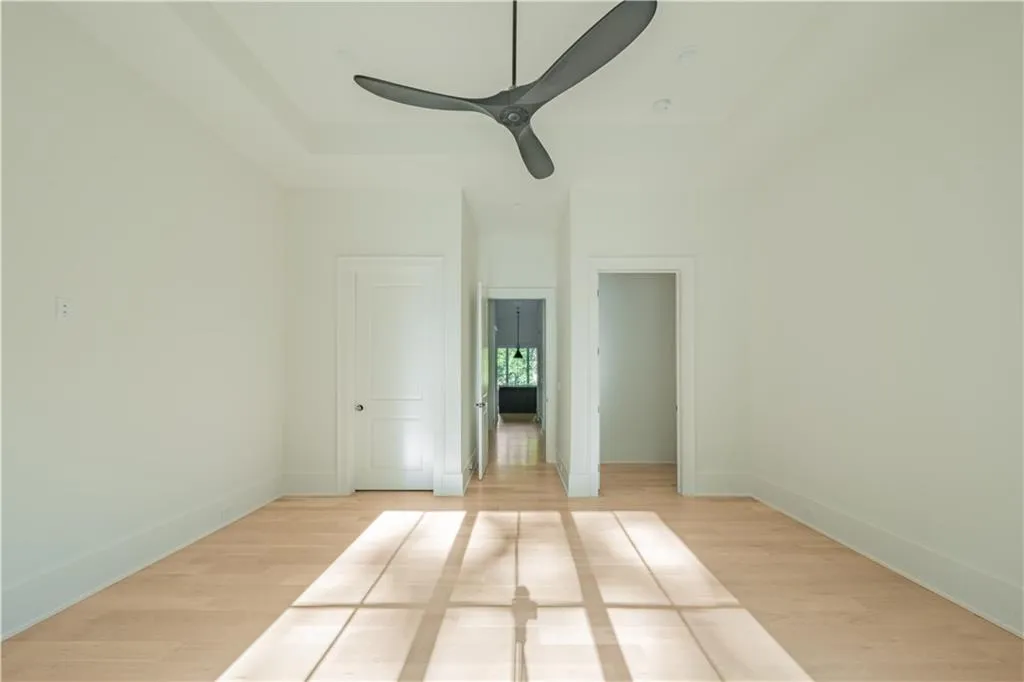 Empty room featuring light hardwood / wood-style flooring and ceiling fan