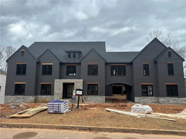 Modern farmhouse style home with stone siding