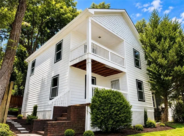 White siding exterior with dark trim windows