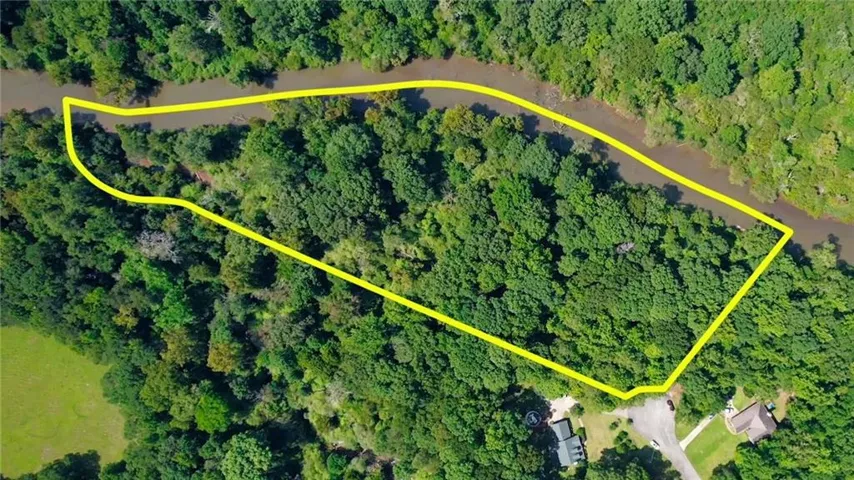 Expansive wooded lot with river frontage