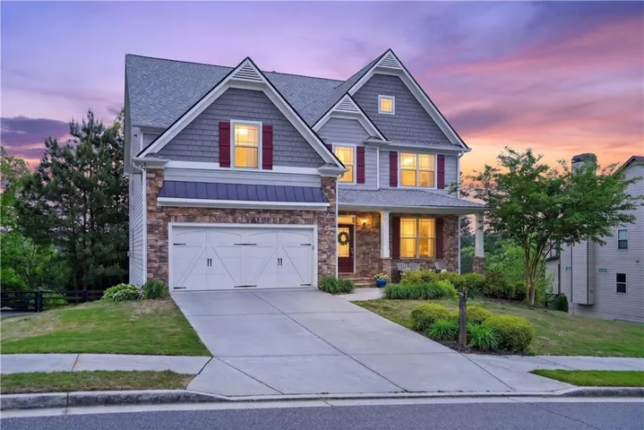 Traditional style residence featuring a stone and siding facade