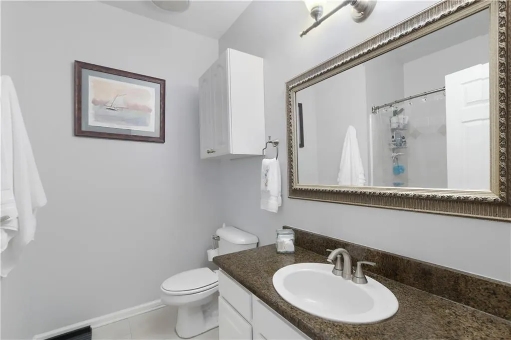 Full bathroom featuring vanity, curtained shower, and tile flooring