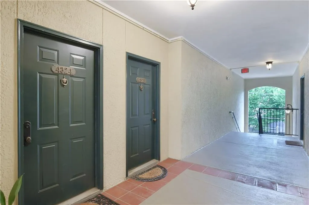 Doorway to property featuring stucco siding