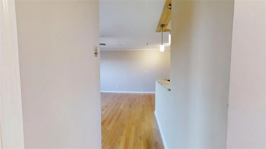 Hallway featuring light hardwood / wood-style floors and crown molding