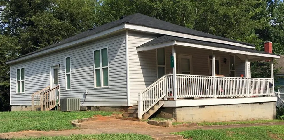 View of front facade with crawl space and a porch