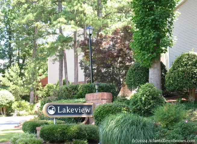 Property entrance featuring a "Lakeview" sign, brick pillar, and a black ornamental light fixture