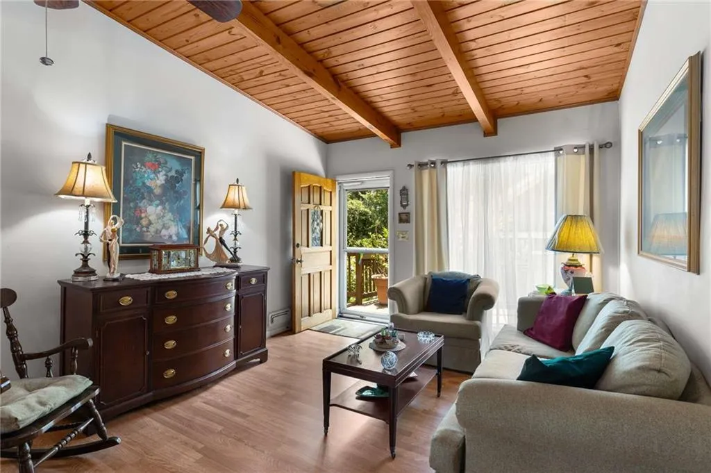 Living area with wooden ceiling and light wood finished floors
