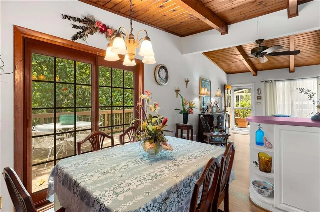 Dining space featuring wooden ceiling, a chandelier, wood finished floors, and a ceiling fan