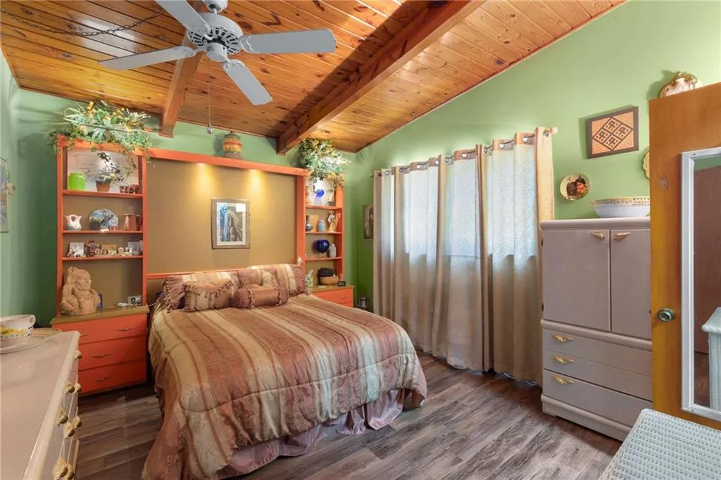 Bedroom with wooden ceiling and wood finished floors