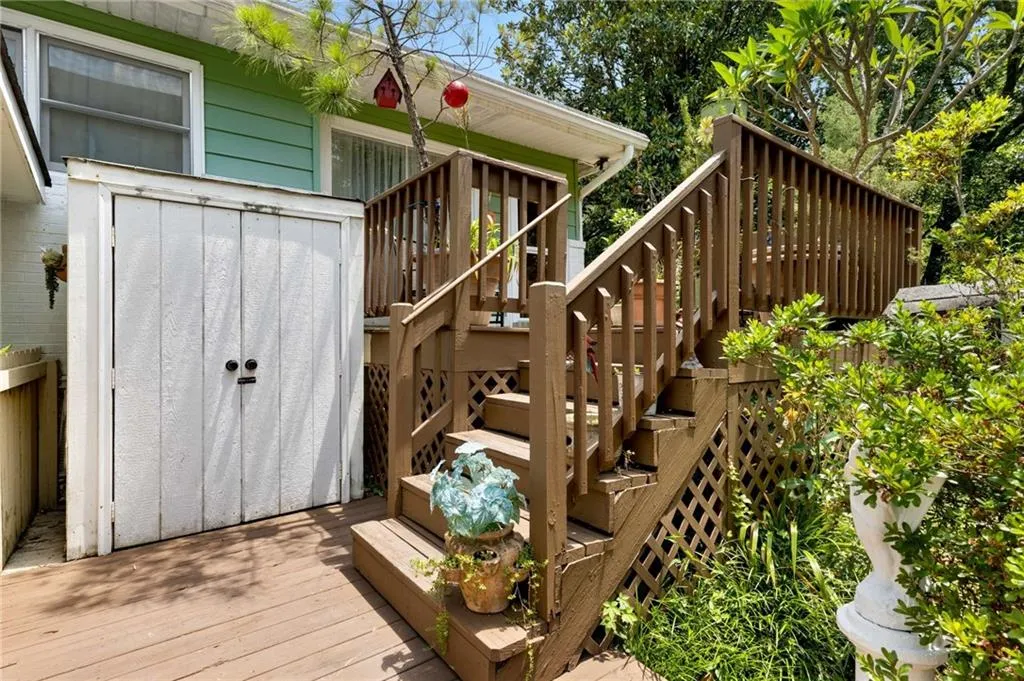 Wooden deck with a storage unit and stairway