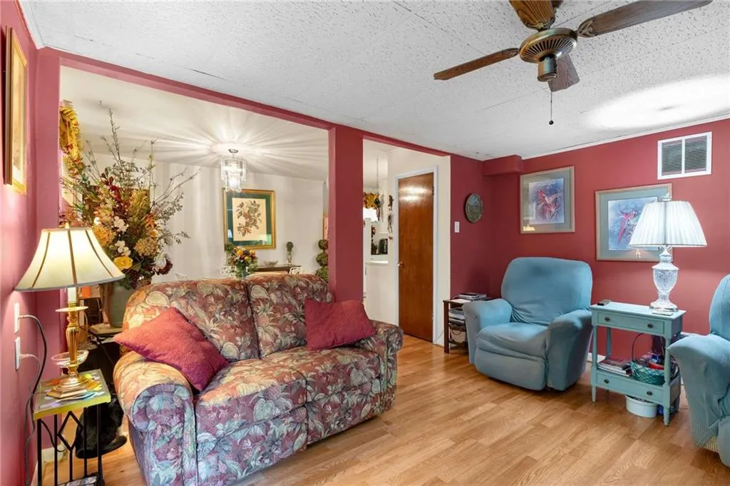 Living room featuring wood finished floors and a ceiling fan