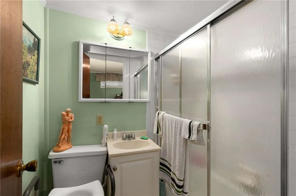 Bathroom with vanity and a stall shower
