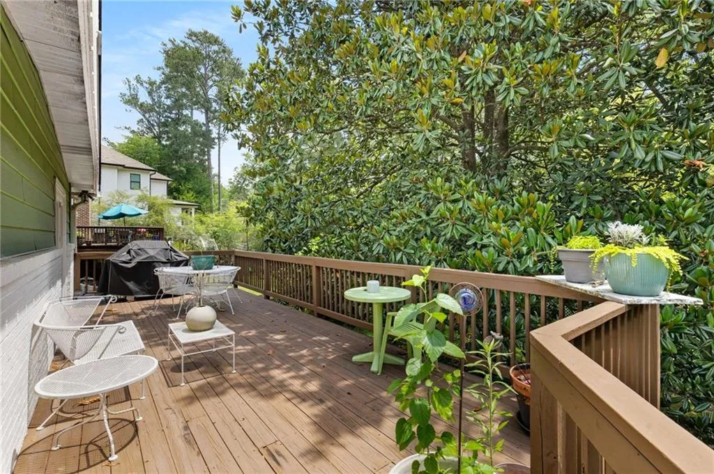 Wooden deck with outdoor dining space and grilling area