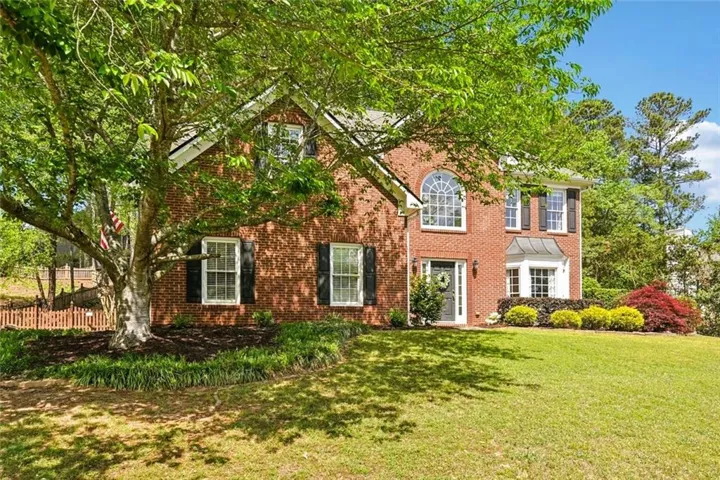 Traditional brick exterior featuring a prominent arch window