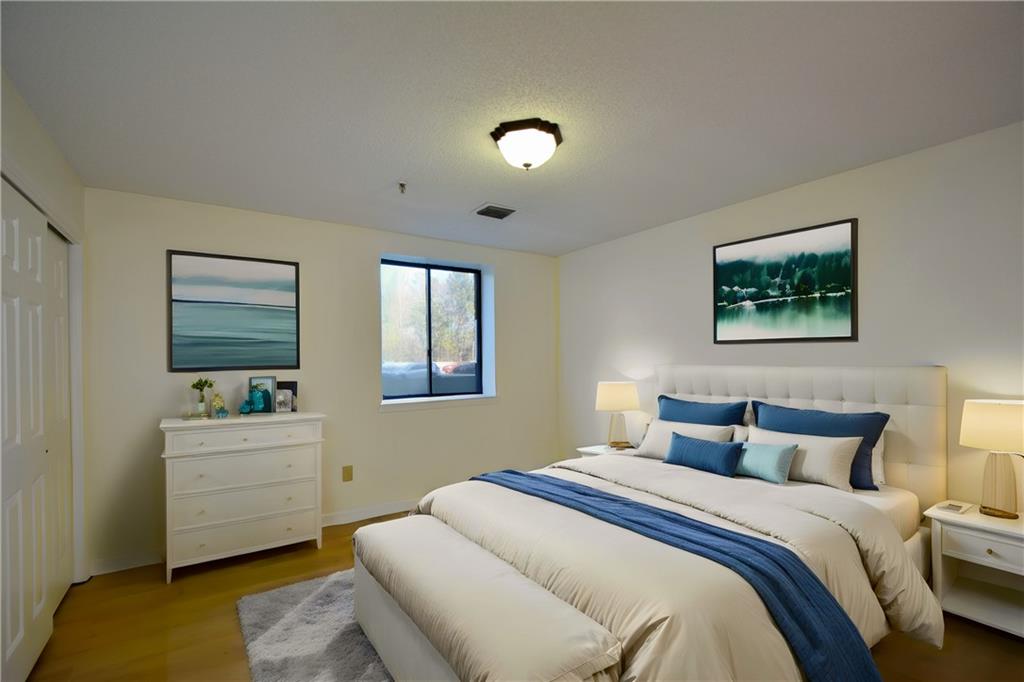 Bedroom featuring wood-type flooring and a closet