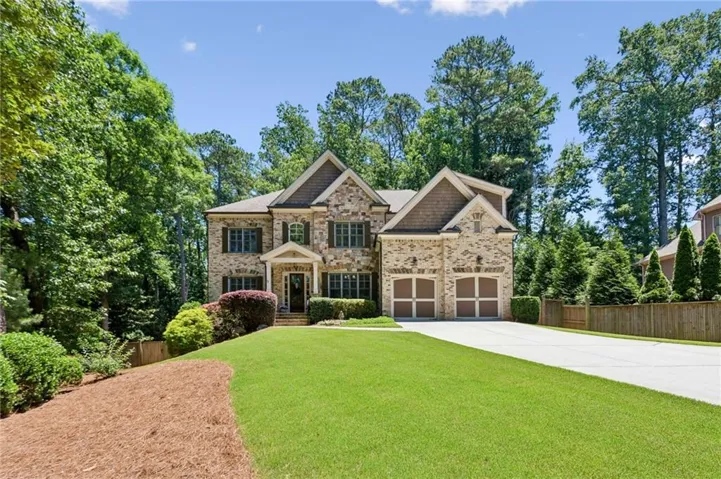 Stately brick and stone exterior with architectural shingles