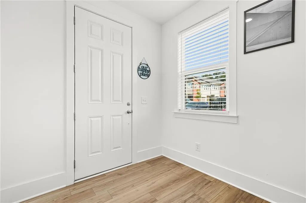 Entrance foyer with light wood-style floors and baseboards