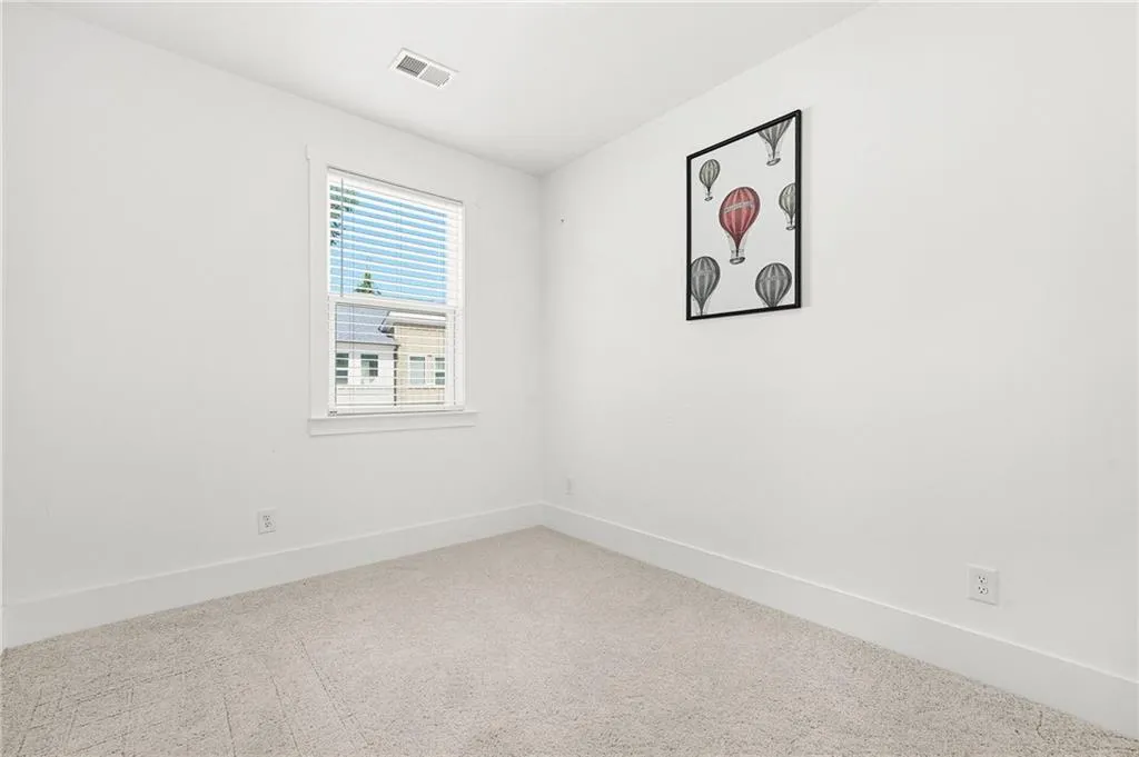 Third bedroom featuring baseboards and carpet flooring
