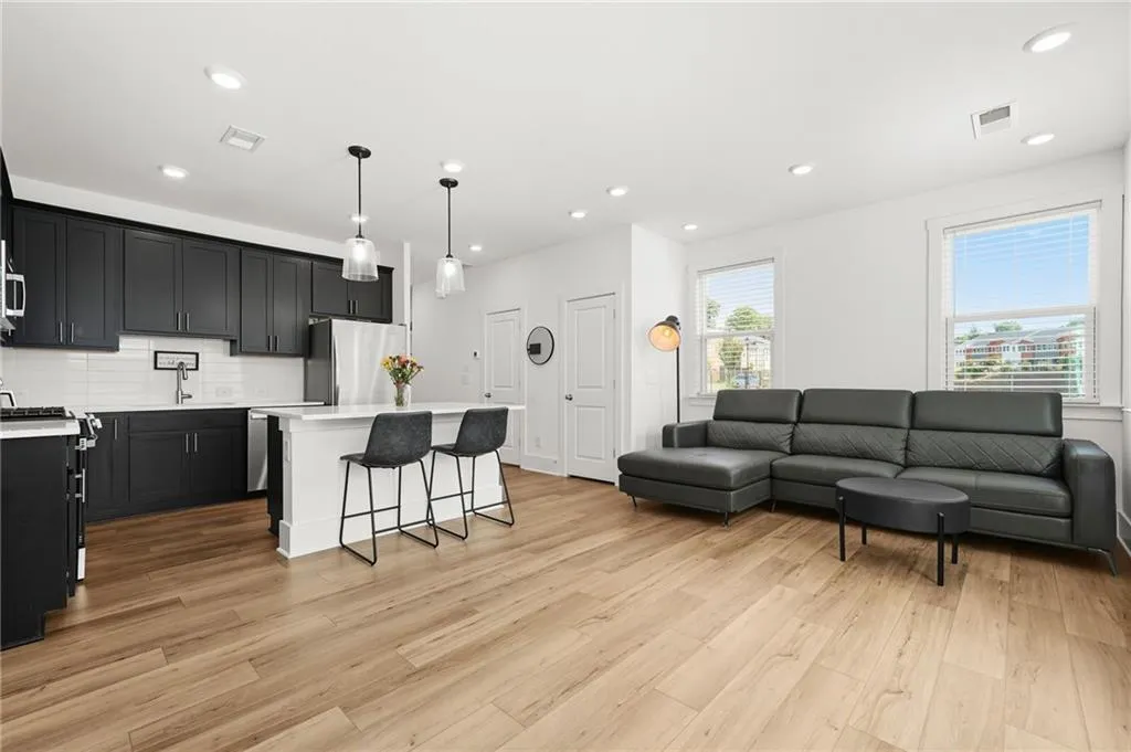 Living area featuring recessed lighting and light wood-type flooring