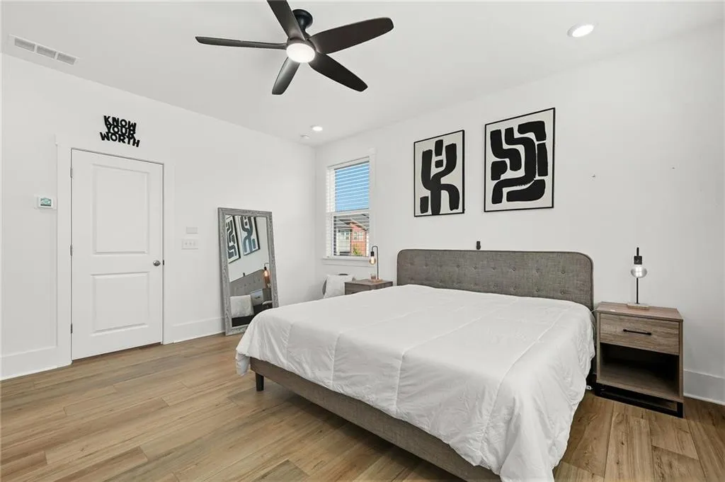 Primary Bedroom featuring light wood-style flooring, a ceiling fan, and recessed lighting