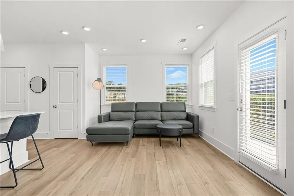 Living area featuring light wood-style floors and recessed lighting