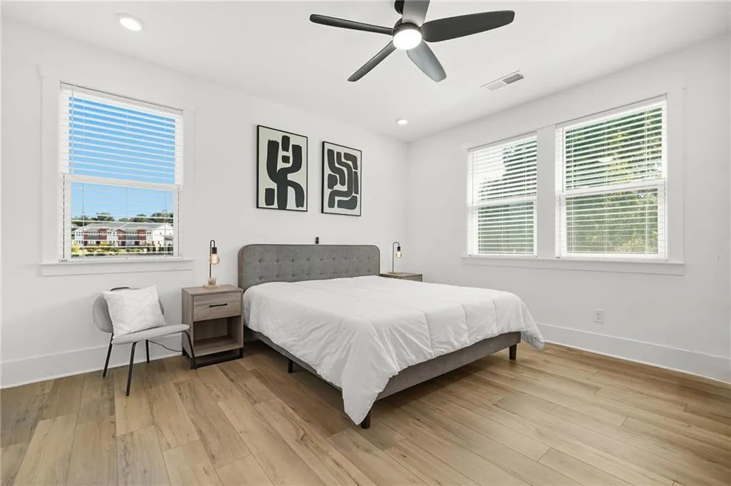 Primary Bedroom with light wood-style flooring, a ceiling fan, and recessed lighting