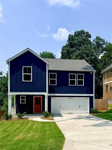 Contemporary facade featuring deep blue vertical siding and white trim