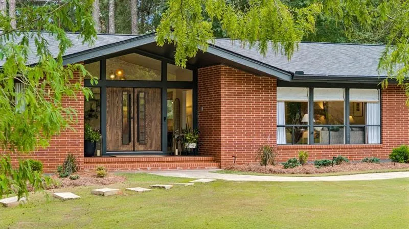 A One-of-a-Kind Mid-Century Modern Sanctuary tucked away on 3 Private, Park-Like Acres, just minutes from the heart of Historic Downtown Senoia.