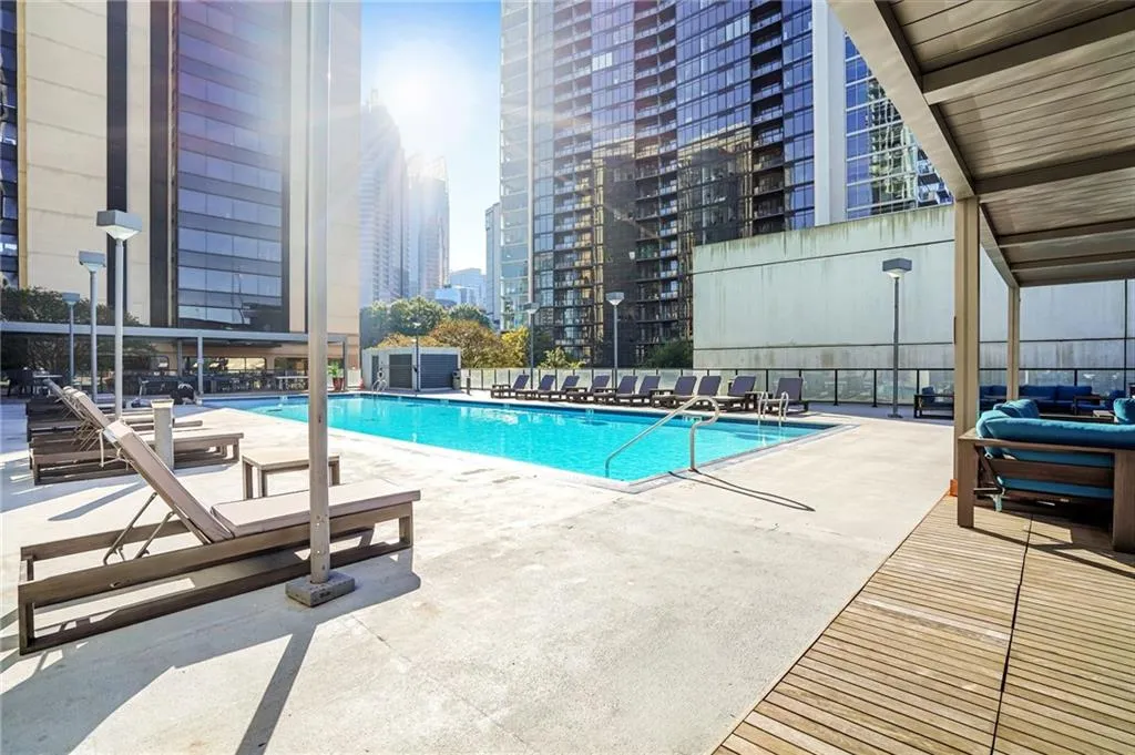 Community pool with a patio and a view of city