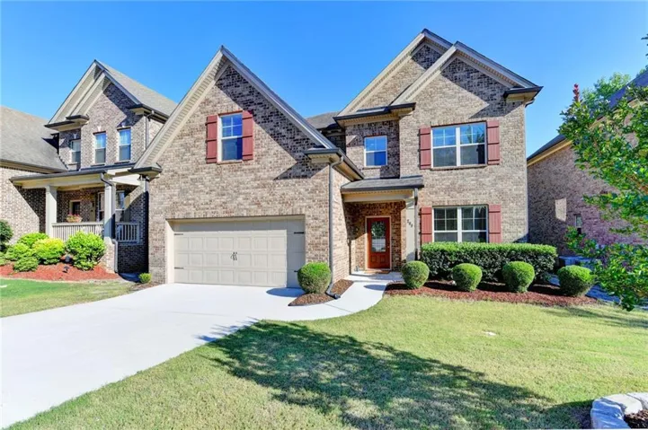4sides Brick exterior with gabled roof lines, attached garage, covered front entry, and mature landscaping