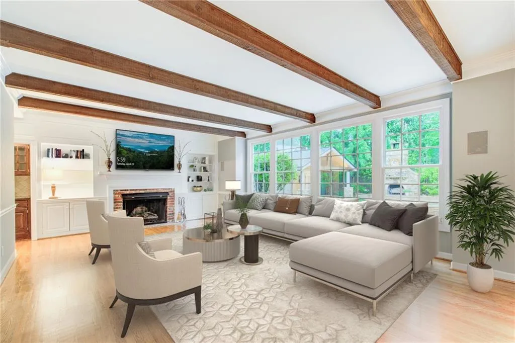 Virtually staged. Take a look at this fireside living room with beams and beautiful hardwood flooring