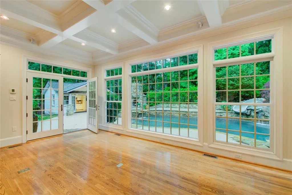 View of the pool house with full bath, Pebble Tek pool, stone firepit and slide.
