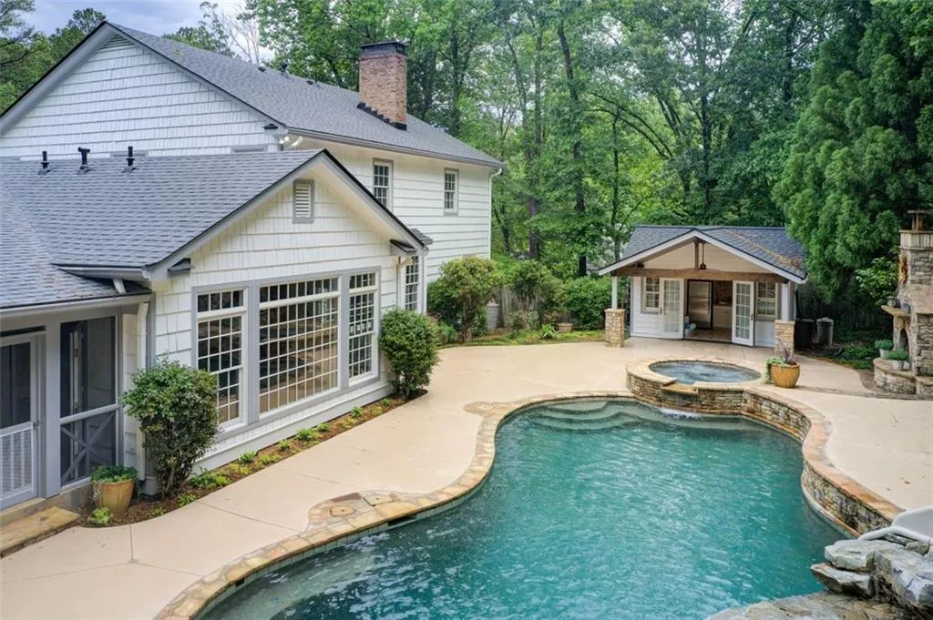 Walk out from the keeping room or screened porch  and you're in a resort. Pebble Tec heated pool, pool house, spa, outdoor fireplace and  outdoor grilling area.