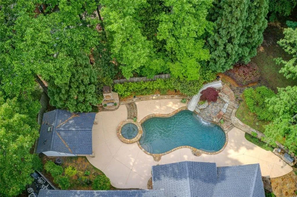 Beautiful outdoor spaces with a pool house, spa, outdoor fireplace, grilling area and a flat attached yard for play time.