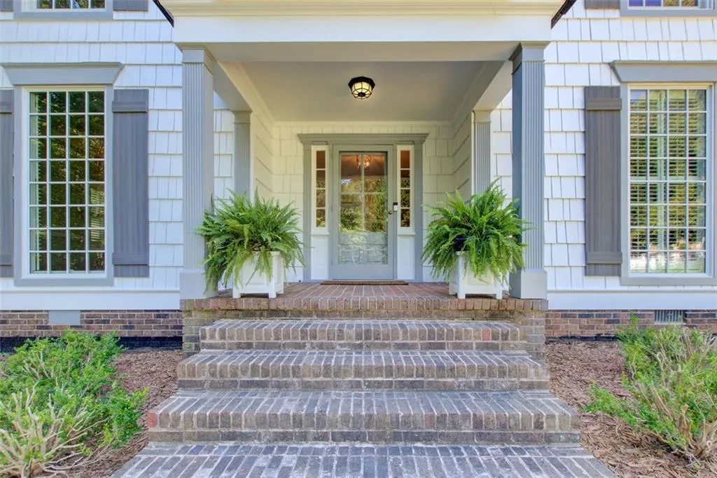 Fresh exterior paint, new shutters and great spaces make this front porch inviting!