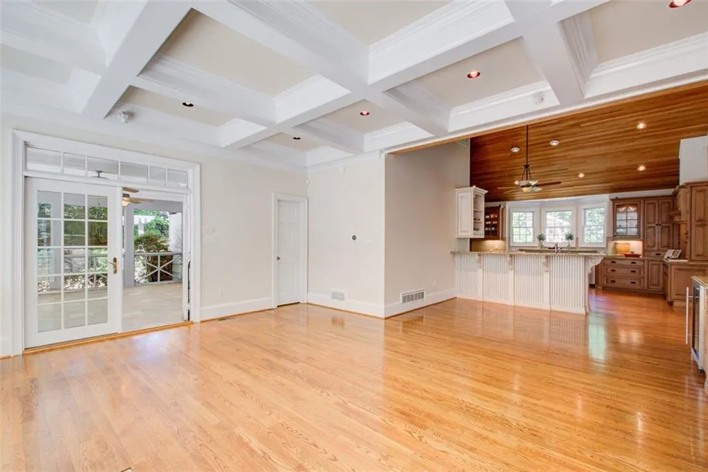 Coffered ceiling keeping room opens to the perfect screened porch.