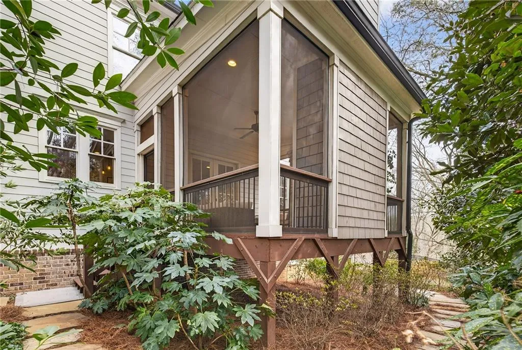 View of covered deck exterior with fireplace